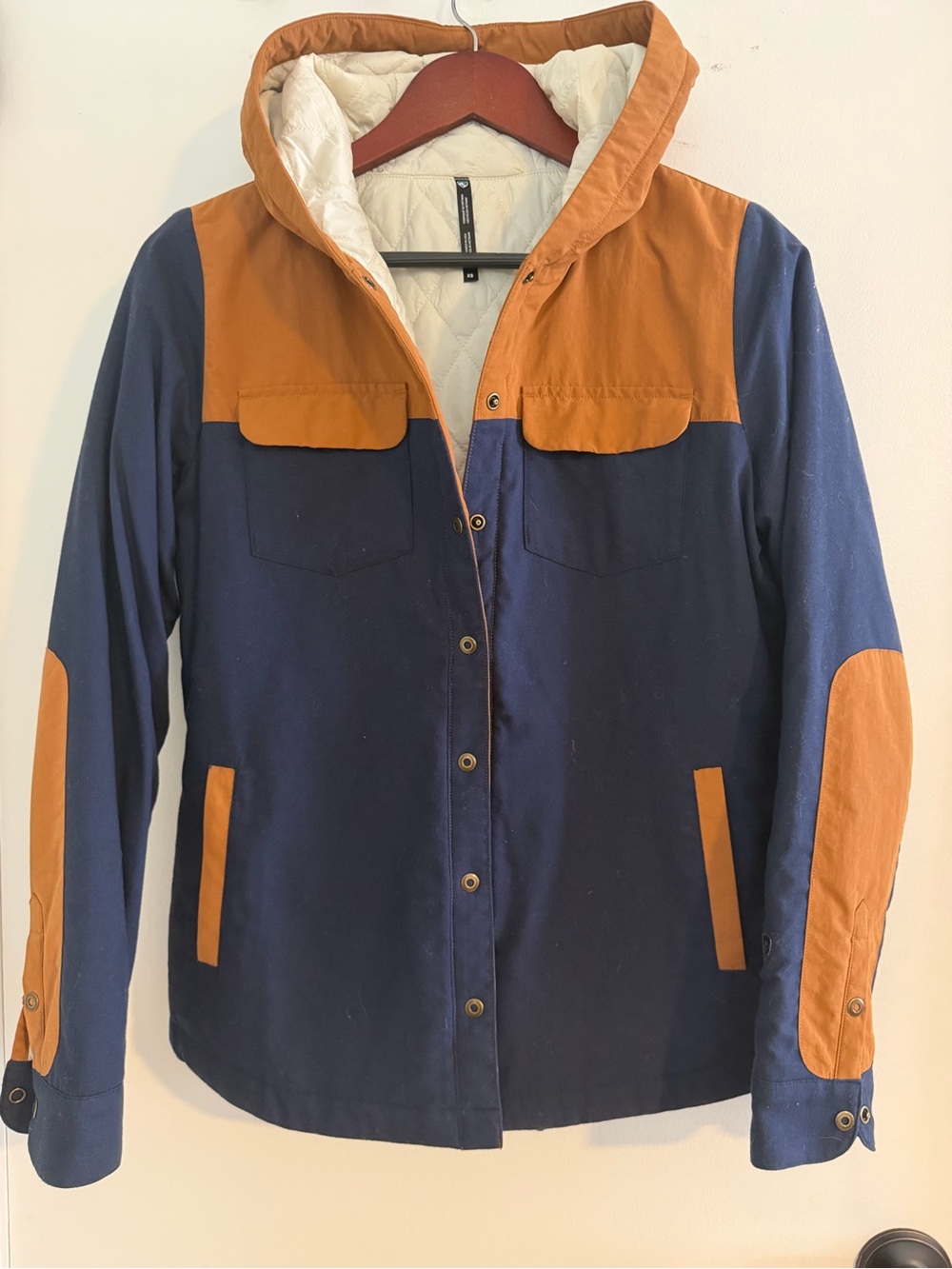 KUHL women's Two-Tone Hooded Jacket in Navy and Camel.